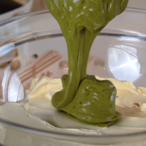 A beautifully layered pistachio tiramisu with creamy layers and a sprinkle of pistachio on top.